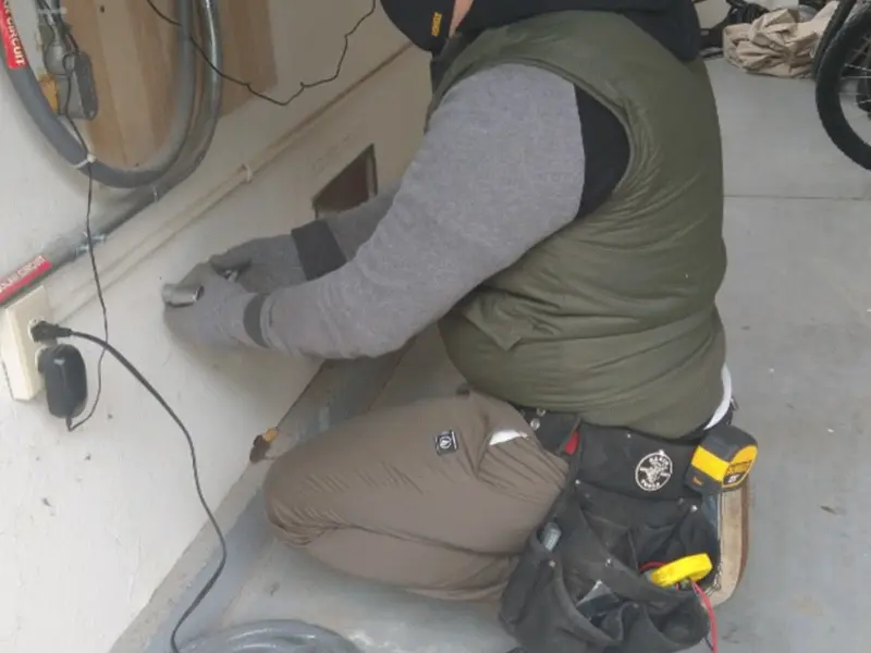 Electrician performing outlet wiring in a Georgetown garage